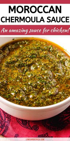 a white bowl filled with green sauce on top of a red and white table cloth