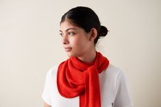 a woman wearing a red scarf and white shirt