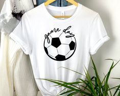 a t - shirt that says gone to the ball on it with a soccer ball