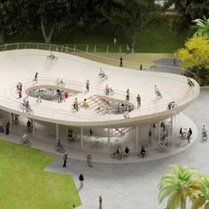 an aerial view of people walking and riding bikes around a circular structure in the middle of a park