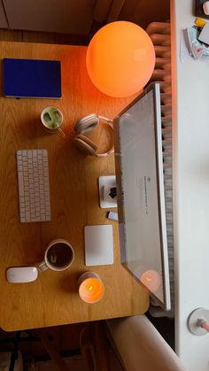 a wooden table topped with a computer monitor and keyboard