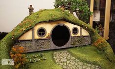 a small house made out of moss and rocks