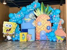 balloons and decorations are set up in the shape of pineapples, spongebob, and other cartoon characters