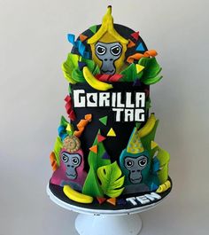 a colorful cake with an image of a gorilla on it's face and the words gorilla tag