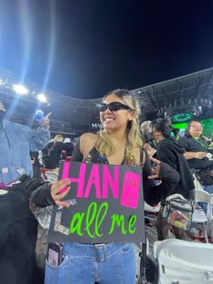 a woman holding up a sign that says hand me at a baseball game with other people in the bleachers