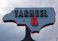 a large sign that says tarheeq on it's side with the word q underneath it