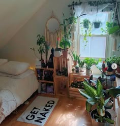 a bed room with a neatly made bed and lots of plants