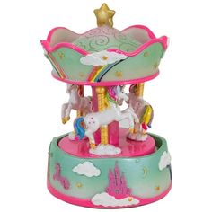 a toy carousel with horses on top of it