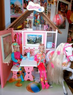 a doll house with two barbie dolls and a horse