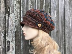 "Style: Chunky newsboy hat. It features a sturdy brim and a strap and handmade wooden buttons. Color: This sample hat is shown in Chocolate Peacock, shades from brown to rust and teal blue. Note: The coloration of these hats come out a little different every time, due to the striped nature of the yarn. If you would like photos of the exact hat that I make for you, feel free to ask, I will be happy to provide them. Sizes: One size fits 20\" to 23\" (50.5 cm to 58 cm) head size. Fiber Content: 100 Hand Knitted Adjustable Hat For Fall, Fall Hand Knitted Cap Hat, Brown Crochet Hat With Short Brim, Adjustable Crochet Hat With Short Brim For Fall, Adjustable Crochet Cap For Fall, Adjustable Brown Crochet Cap, Adjustable Yarn Hats For Fall, Brown Crochet Hat With Curved Brim For Fall, Multicolor Flat Cap For Fall