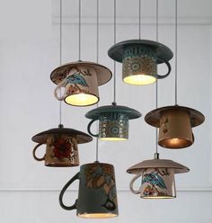 several coffee cups hanging from the ceiling