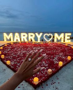 a person's hand on top of a rug with the words marry me in front of it