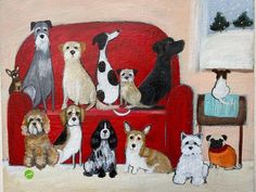 a group of dogs sitting on top of a red couch