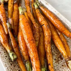 roasted carrots on a white platter ready to be eaten