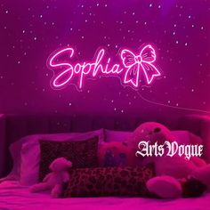 there is a bed with stuffed animals on it and the name sophiia written in pink