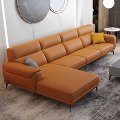 an orange leather couch sitting in front of a coffee table