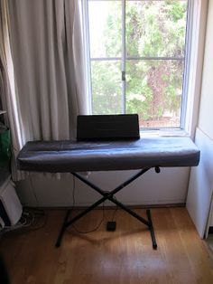 an ironing board sitting in front of a window