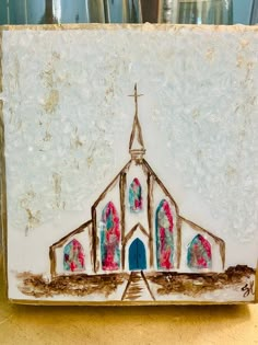 a ceramic tile with a church painted on it