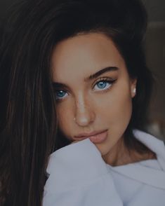 a woman with blue eyes and long hair