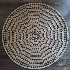 a white doily sitting on top of a wooden table