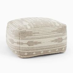 a small ottoman that is made out of fabric and has a pattern on the front