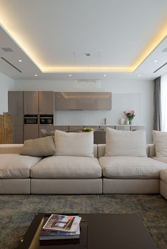 a living room filled with lots of white furniture