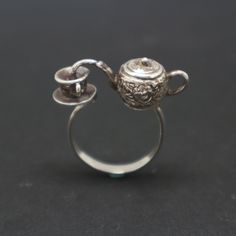 "This unique teapot ring was created and inspired by Victorian Era. Victorian Era was a period of Queen Victoria reign within 20 June 1837 - 22 Jan 1901 in the United Kingdom. During this time, people love to have evening tea with some biscuit before having dinner. This ring was made with 925 Sterling Silver and oxidized to have a antique or vintage feel. Stylish, Unique, Special and Weird ring ever made! Base Material: Sterling Silver Size: 29mm X 10mm (W) (Approximately) Ring Size: US 4 - US 1 Victorian Teapots, Teapot Jewelry, Stile Harry Potter, Dope Jewelry, Funky Jewelry, Jewelry Lookbook, Oct 30, Jewelry Inspo, Dream Jewelry