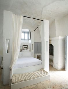 a bedroom with white walls and flooring is shown