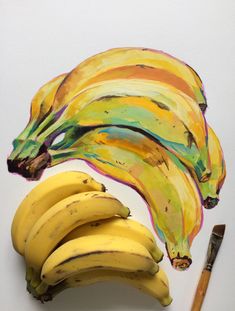 some bananas are sitting next to a pencil and watercolor paper on a white surface