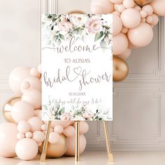 a welcome sign is surrounded by balloons and flowers in front of a white backdrop that reads, welcome to ausias bridal shower