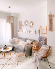 a living room filled with lots of furniture next to a wall mounted clock on the wall