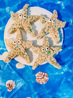 rice krispy treats with googly eyes and seashells are on a plate