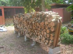 logs stacked on top of each other in the yard