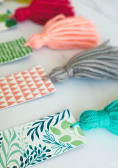 small tags with tassels are lined up on a table