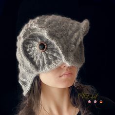 a woman wearing a knitted hat with an eyeball