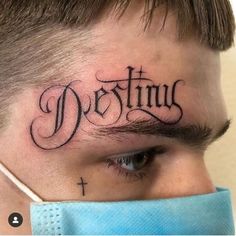 a man with a cross on his forehead has the word destinus written in cursive font