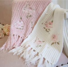 two knitted blankets with flowers on them