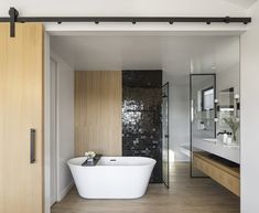 a bath tub sitting in the middle of a bathroom