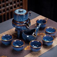 a table topped with blue dishes and cups