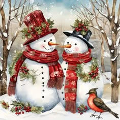 two snowmen with hats and scarfs standing in the snow next to each other