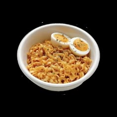 a white bowl filled with noodles and hard boiled eggs