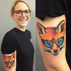 a woman with tattoos on her arm and leg, both showing the face of a fox