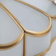 a close up view of a mirror with gold trimmings on the edges and sides