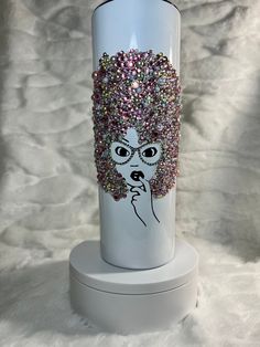 a white vase with a woman's face painted on it