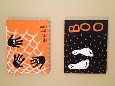 two halloween cards on the wall with handprinted ghostes and boooos