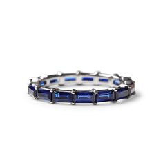 a white gold ring with blue sapphire stones