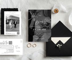 the wedding stationery is laid out on top of the table, including an envelope and ring