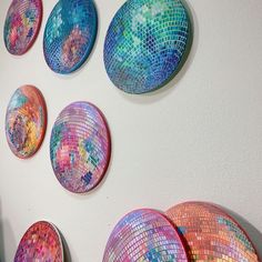 many colorful plates are hanging on the wall