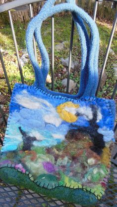 a handbag is sitting on the back of a chair in front of a fence