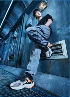 a young man is doing a trick on his skateboard in an industrial building area